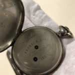 An open pocket watch showing the engraving of Ferris & Son, Wilmington, Del