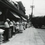 A group of people loading cartons of food